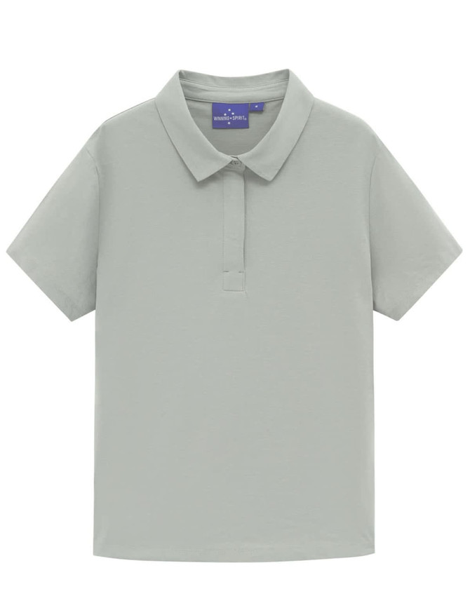 A light grey women's polo shirt with a collared neckline and short sleeves, featuring a logo on the upper part.