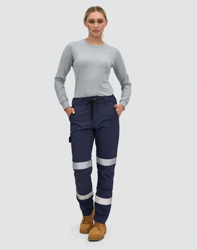 Navy blue work pants with reflective tape, featuring pockets and a comfortable fit, modelled by a woman.
