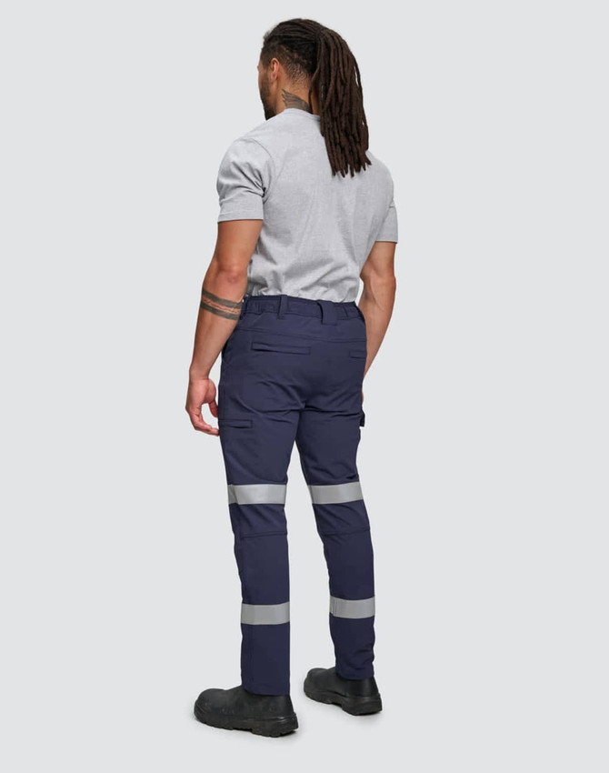 Flexi work pants in navy with reflective tape details, worn by a person seen from the back. Features a logo.