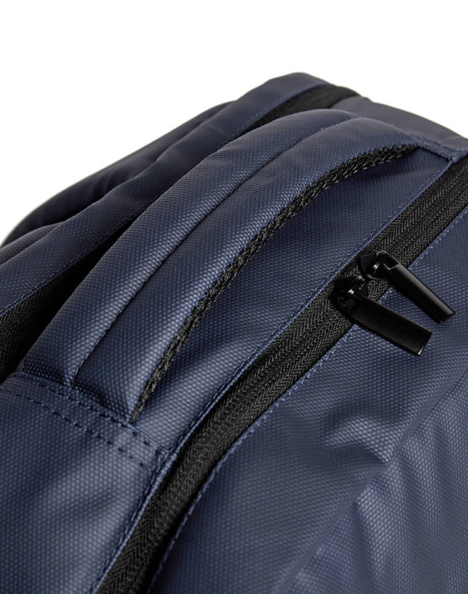 A dark navy backpack featuring a smooth texture and zippered compartments. The product has a logo.
