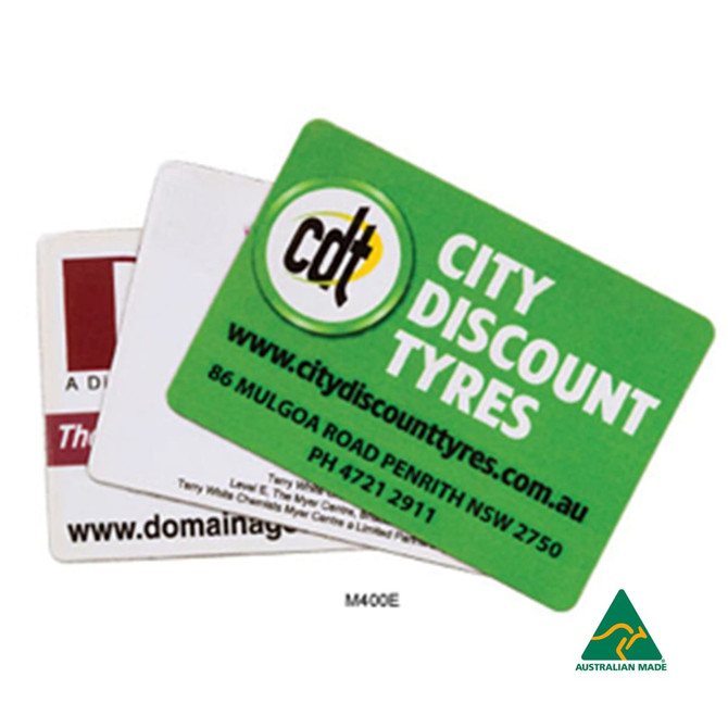 Three rounded corner fridge magnets in various colours, featuring different logos and designs, including one with a green background.