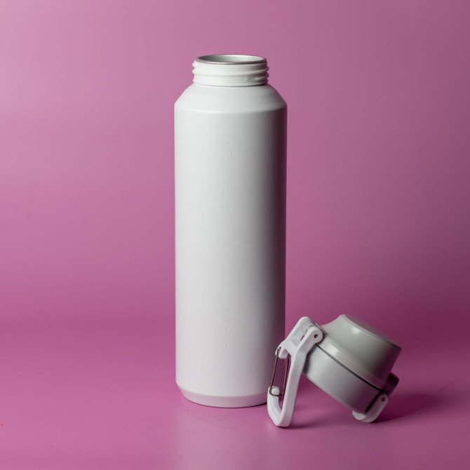 A drink bottle in white, featuring a screw-on lid, positioned against a pink background. It has a logo on the side.