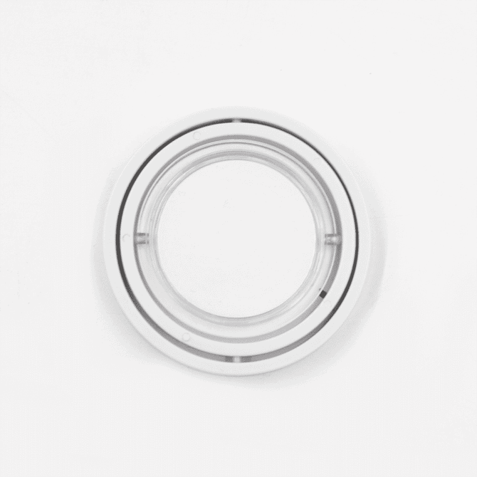 A transparent circular fidget spinner with two concentric rings. It features a smooth surface and a central spinning axis.