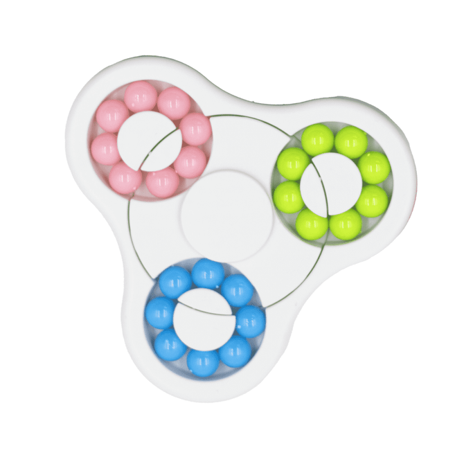 A colourful puzzle game featuring pink, blue, green, and yellow beads arranged in a circular design with a central section.