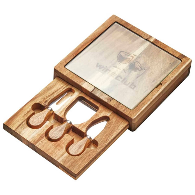 A wooden cheese board set featuring a glass top and three stainless steel tools, presented in an elegant storage box.