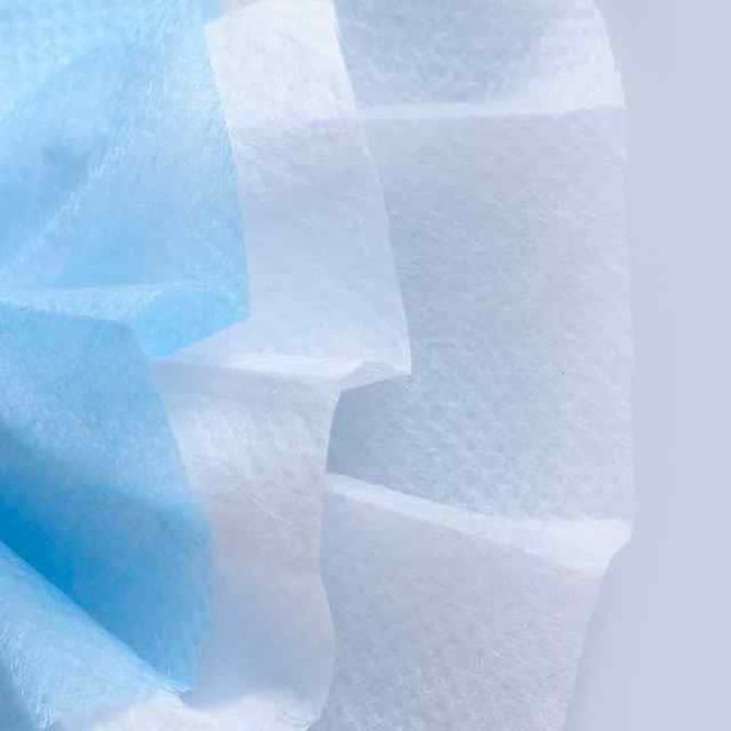 A triple layered cloth face mask in light blue, featuring a soft fabric texture and a central pleated design.