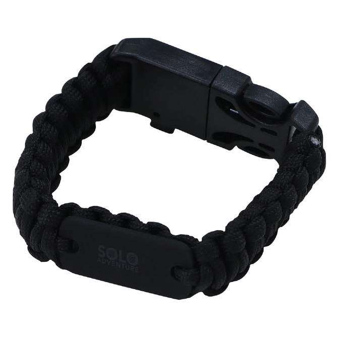 A black survival band made of braided paracord with a plastic clasp, featuring a small logo.