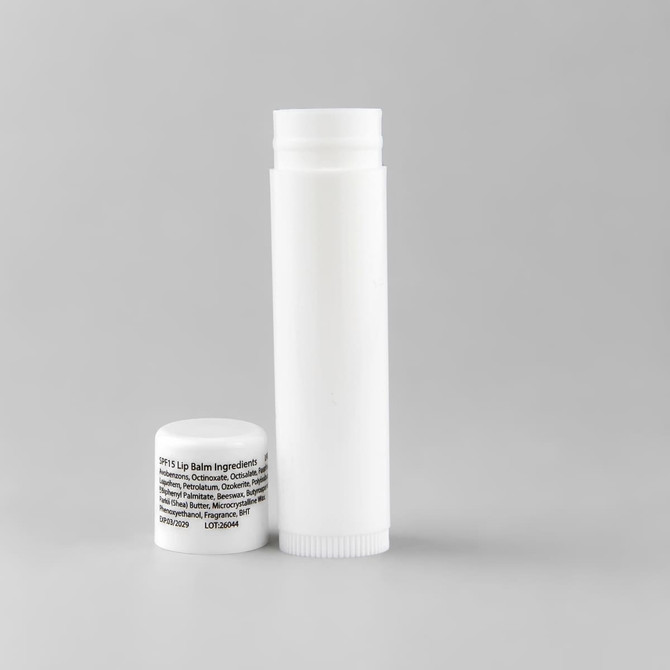 A white lip balm container and a small white cap, featuring an unobtrusive logo.