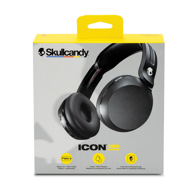 A black pair of wireless headphones in a packaging box featuring a logo and a yellow hanging tag.