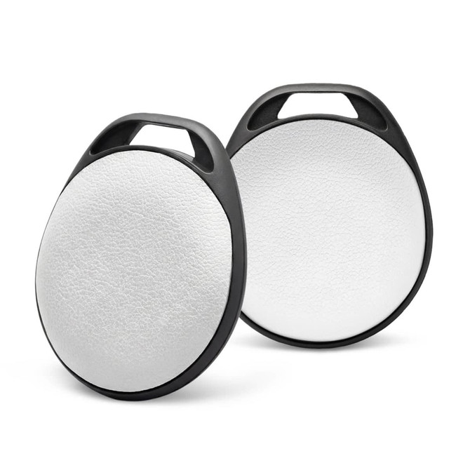 Two round Bluetooth trackers with a white circular surface and black edges, featuring a handle for easy attachment.