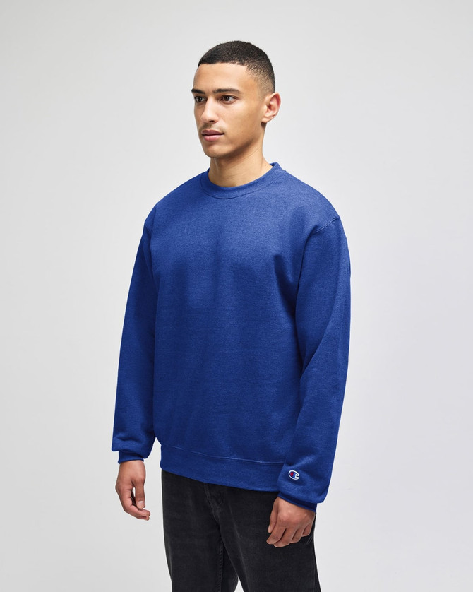 A blue Champion Powerblend® adult crewneck sweatshirt displayed on a model standing against a plain background.