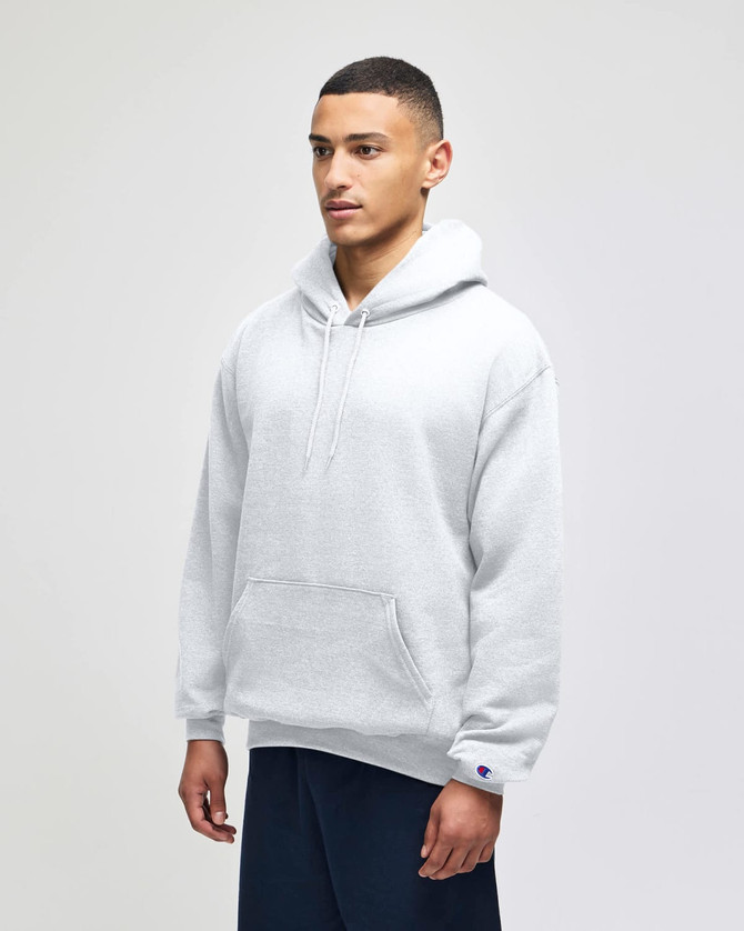 A grey pullover hooded sweatshirt with a front pocket and branding on the sleeve, modelled by a person.