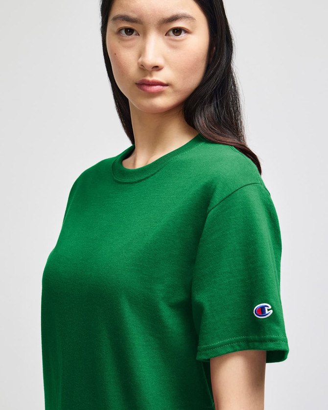 A green Champion adult short-sleeve T-shirt featuring a logo on the sleeve.