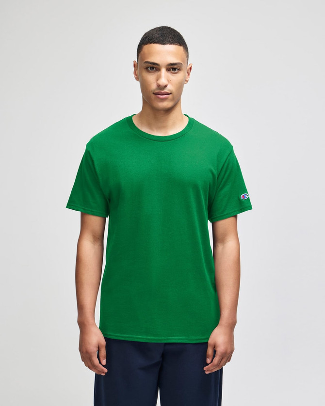 A green short sleeve t-shirt featuring a logo on the sleeve, displayed on a model.