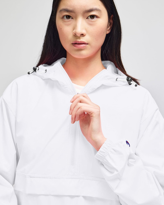 A packable anorak jacket in white, featuring a drawstring hood and a small logo on the sleeve.