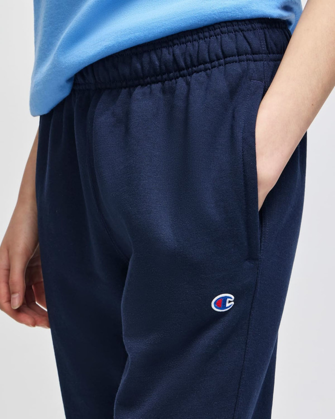 Navy fleece jogger featuring an elastic waistband and side pockets, with a small logo on the side.