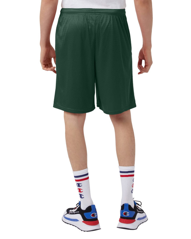 Green mesh shorts with pockets, featuring a logo, view from the back. Styled with white socks and sneakers.