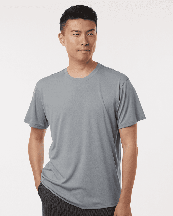 A men's performance t-shirt in grey, featuring a relaxed fit and a branding logo on one sleeve.