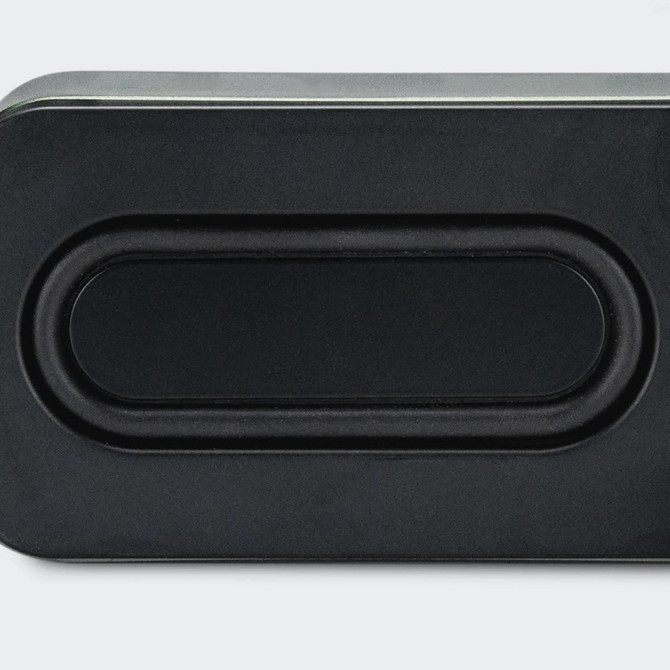 A rectangular black bass speaker featuring a smooth surface and a central oval design element.