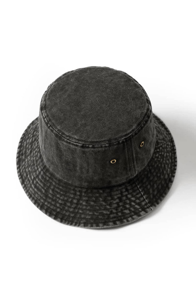 A black washed bucket hat made from 280gsm 100% cotton drill, featuring eyelets and a textured design.