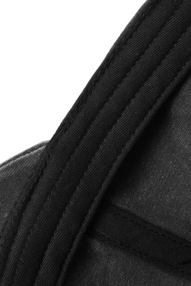 A close-up of a black cotton cap featuring detailed stitching and fabric texture, with a logo present.