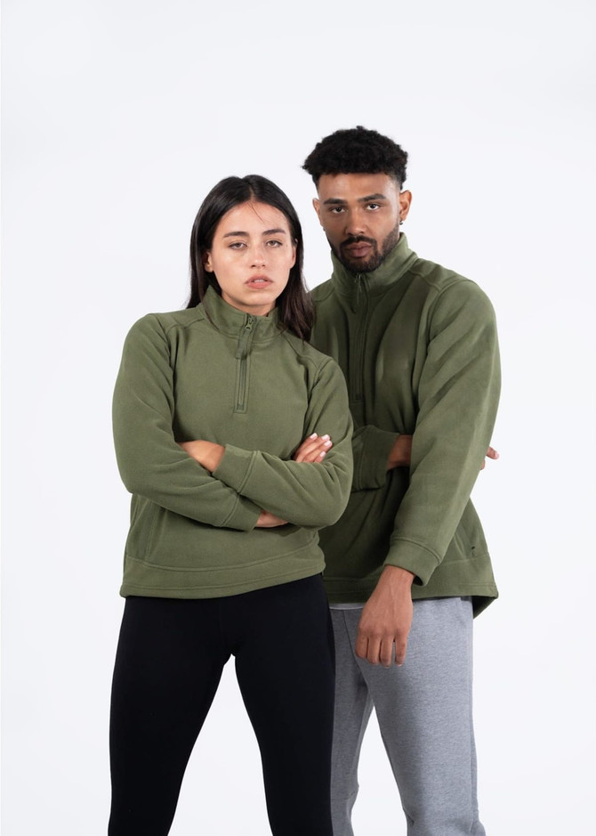 A green polar fleece half zip top for men and unisex, featuring a logo, worn by a model pair.