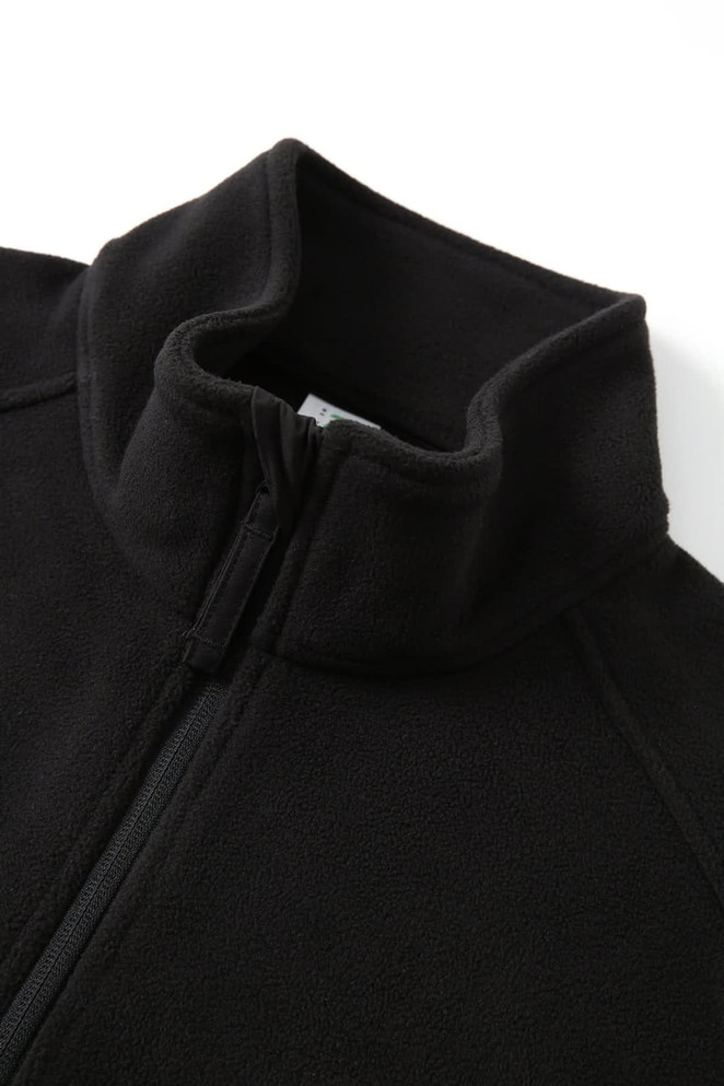 A black polar fleece half zip top with a high collar and a zip closure. The material appears soft and warm.
