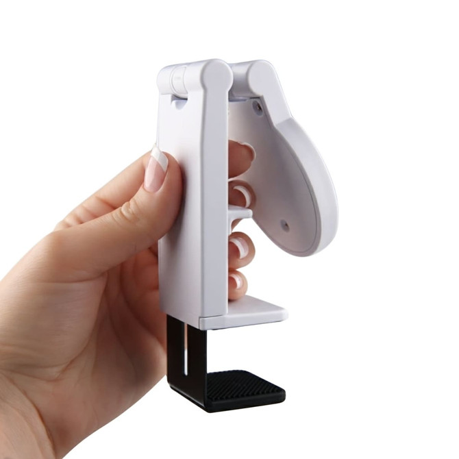 A white mobile phone stand held in a hand, featuring a black base for stability.