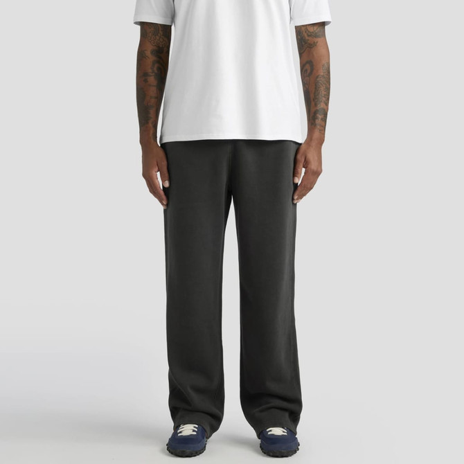 Relax Faded cuffless track pants in black, styled with a white T-shirt and navy shoes, featuring a logo.