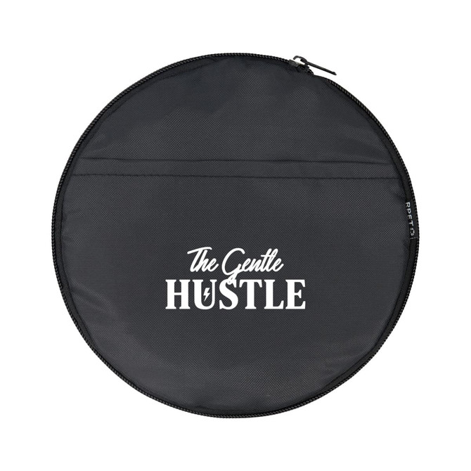 A round black bag with a zip, featuring a logo and the words "The Gentle Hustle" in white.