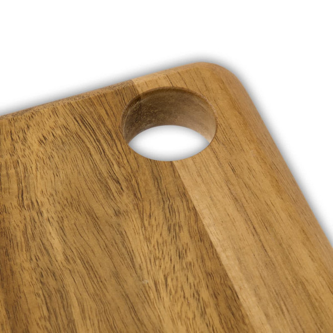 A wooden serving board with a natural acacia finish and a circular cut-out in one corner.