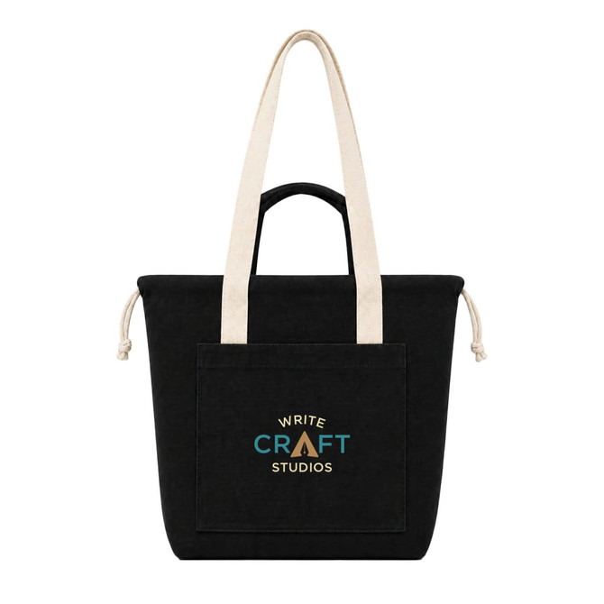 A black tote bag with long beige handles and a front pocket featuring a logo.