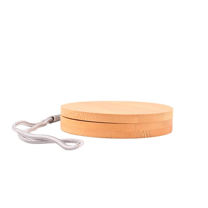 A circular bamboo product with a grey strap, featuring a smooth, natural finish.