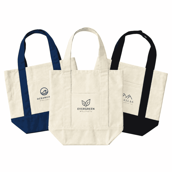 Three mini canvas tote bags in natural, navy blue, and black with various logos on the front.