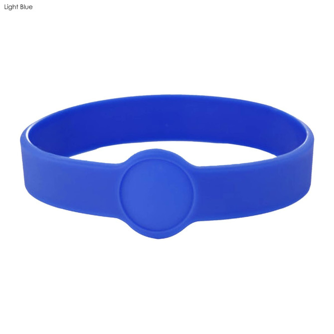 A light blue silicone wristband featuring a circular design. The band includes a logo or branding element.