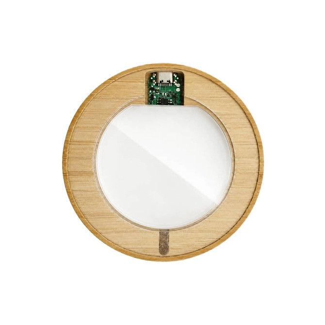 A wireless charger with a round bamboo design and a sleek glass surface, featuring a visible circuit board.