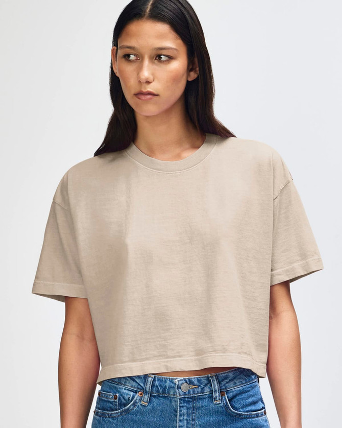 A heavyweight cotton women's crop boxy t-shirt in a neutral beige colour, featuring a round neckline and short sleeves.