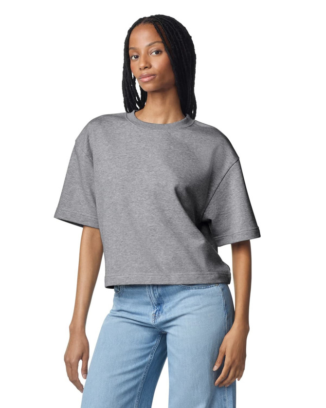 A grey women's mid-length boxy top with short sleeves, featuring a relaxed fit and a brand logo.