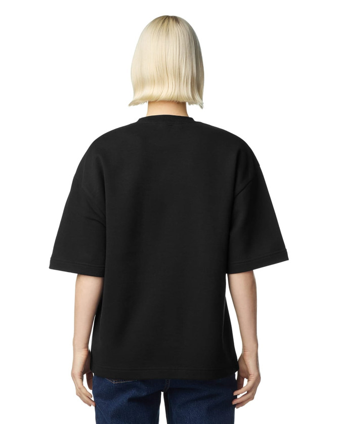 A black oversized boxy top made from French terry fabric, featuring a simple design and a logo on the back.