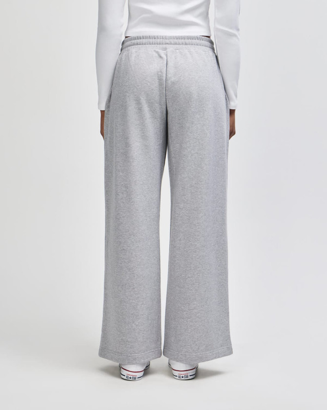 Grey women's wide leg pants with an elastic waistband, featuring a logo on the back.