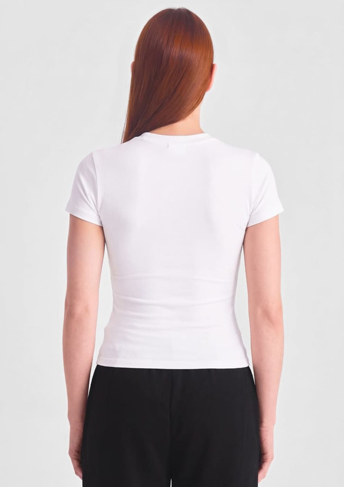 A white women's baby tee displayed from the back, featuring a fitted design and short sleeves.