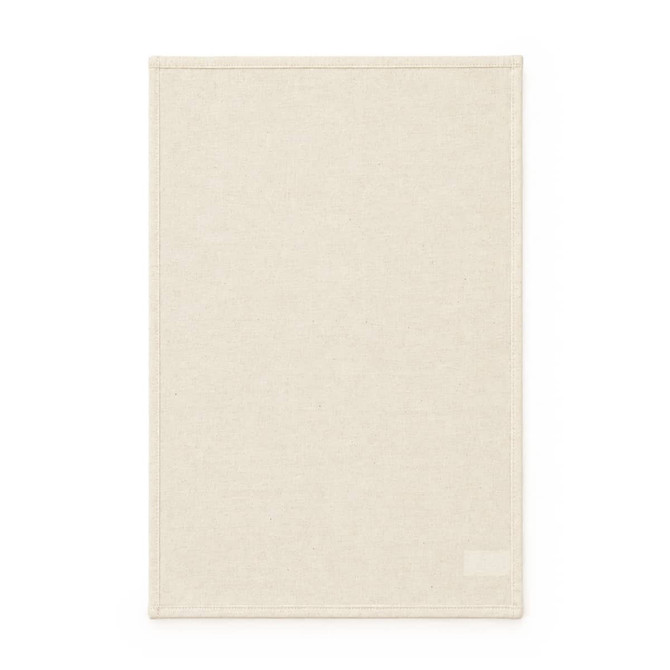 A medium cotton tea towel in a light cream colour with a simple border and a logo at the bottom.