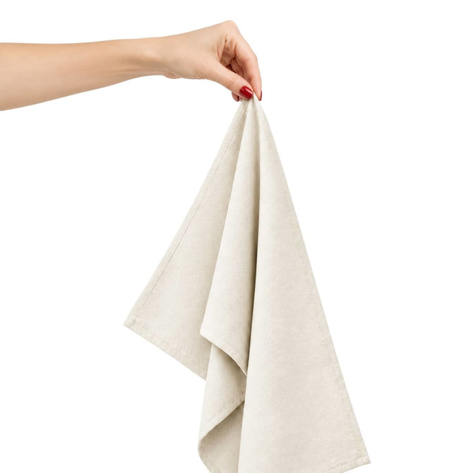 A hand holds a light beige cotton tea towel, showcasing its soft fabric and folded design.