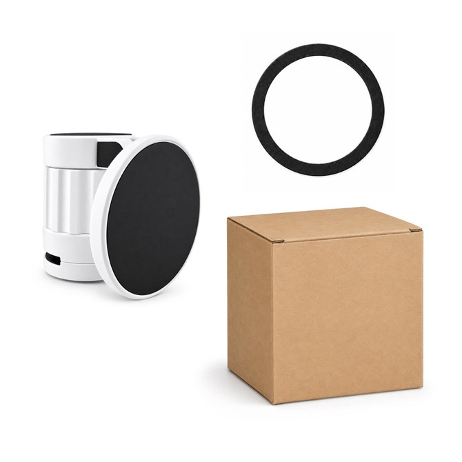 A white and black phone holder with a circular base, alongside a black ring and a brown box.
