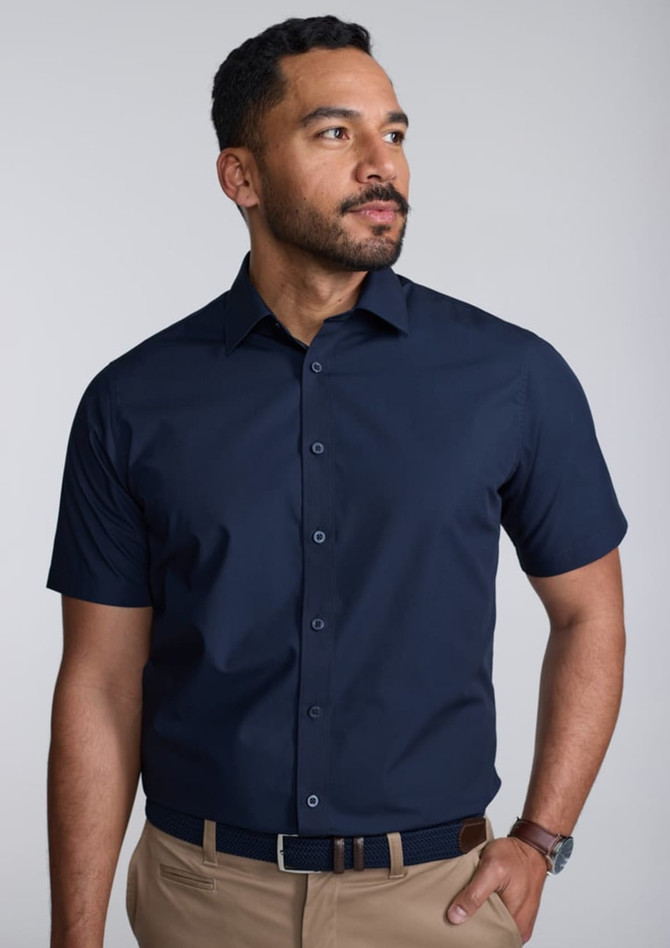 A classic fit short sleeve shirt in navy blue, featuring a button-up front and a branded logo.