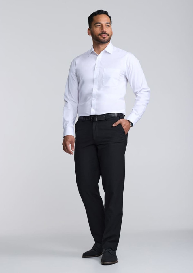 A classic fit long sleeve shirt in white, paired with black trousers, worn by a man standing confidently.