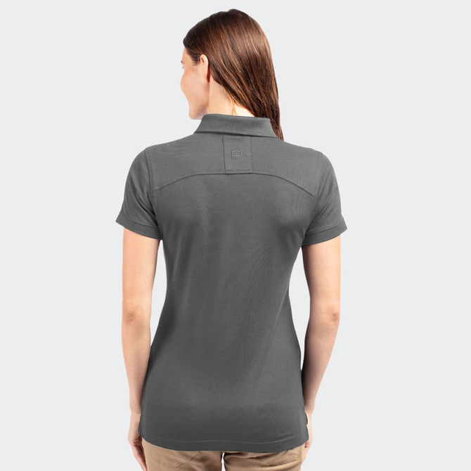 A women's polo shirt in dark grey, featuring a collared design and a logo on the back.