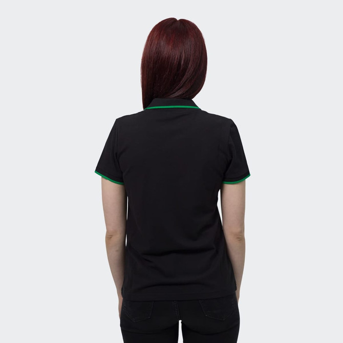 A women's black polo shirt featuring green trim on the collar and sleeves. The shirt has a logo on the front.
