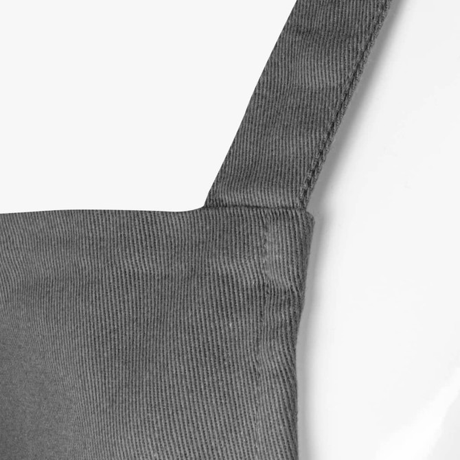A grey Santini apron featuring a textured fabric and a strap for securing around the neck.