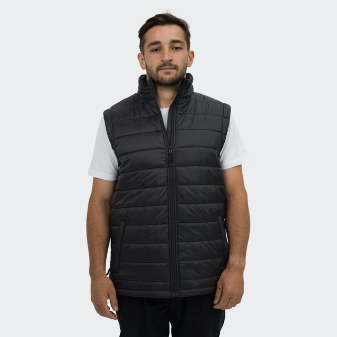 A man wearing a black puffer vest with a high collar and zippered front, featuring side pockets.